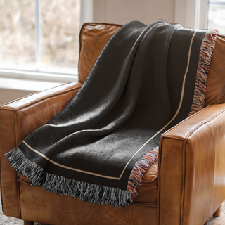 American made custom woven blanket on a leather chair from The Blanket Shop