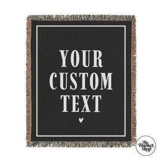 Black blanket with customizable text and a heart symbol, featuring 'The Blanket Shop' logo.
