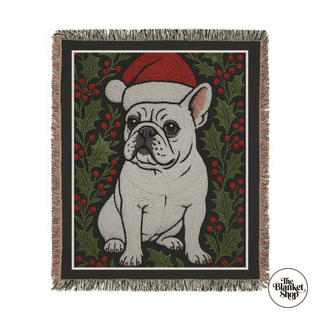 Black woven blanket featuring a Santa hat wearing French Bull dog and a white background, and the 'The Blanket Shop' Logo