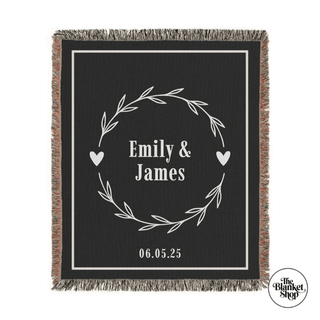 Blanket with 'Emily & James' and date design on a black background and The Blanket Shop Logo