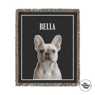 Blanket with a dog's face and name 'Bella' on a black background, branded 'The Blanket Shop'.
