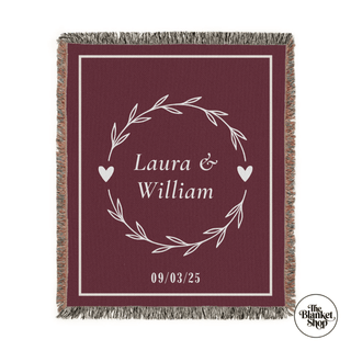 Custom throw blanket with 'Laura & William' and date design on a black background and The Blanket Shop Logo