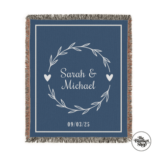 Custom throw blanket with 'Sarah & Michael' and date design on a black background and The Blanket Shop Logo