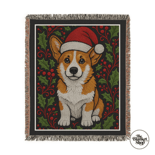 Custom throw blanket with a corgi wearing a Santa hat surrounded by holly leaves and berries, branded 'The Blanket Shop'.
