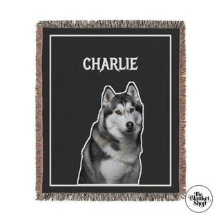 Custom throw blanket with a dog illustration and 'Charlie' text on a black background and The Blanket Shop