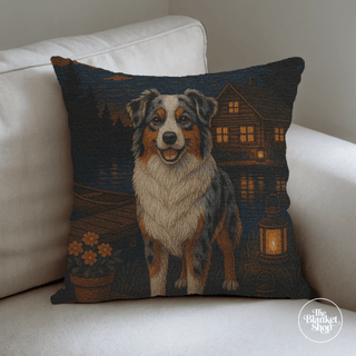 Custom throw pillow featuring a sheep dog near a lake design on a white couch and The Blanket Shop Logo
