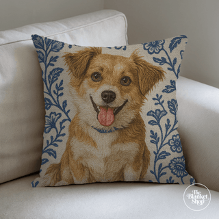 Custom throw pillow with a dog and blue and white floral design on a white couch with The Blanket Shop Logo
