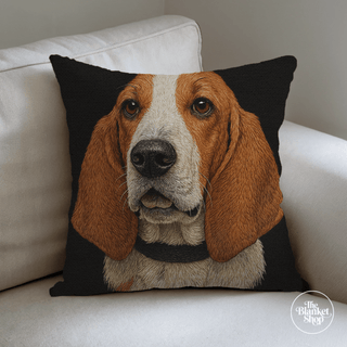 Custom woven throw pillow with a dog's face design on a white couch and The Blanket Shop Logo