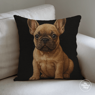 Custom woven throw pillow with a puppy french bulldog dog's face design on a white couch and The Blanket Shop Logo