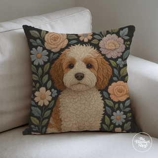 Floral custom throw pillow with a cute dog design on a white couch with The Blanket Shop Logo