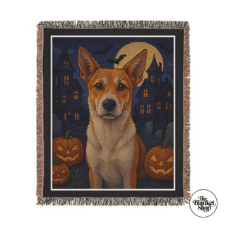 Halloween-themed throw blanket with a dog and pumpkins design, featuring 'The Blanket Shop' logo.