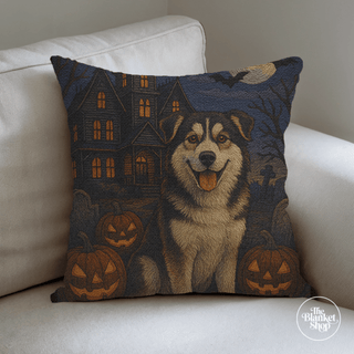 Halloween-themed cotton throw pillow with a dog and pumpkins on a white couch from The Blanket Shop