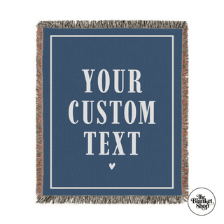 Navy blue blanket with 'Your Custom Text' text and a heart symbol, featuring The Blanket Shop logo.

