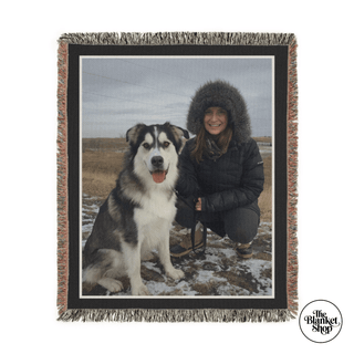 Personalized Throw Blanket with a photo of a woman and her dog on a snowy landscape, featuring The Blanket Shop logo.