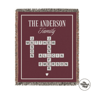 Personalized family blanket with crosswords of names on a red background from The Blanket Shop