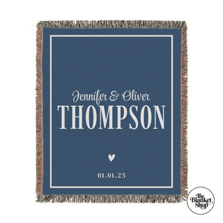 Personalized throw blanket with names and date on a blue background with The Blanket Shop Logo