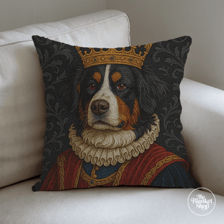 Personalized throw pillow with a dog design wearing a crown on a white couch with The Blanket Shop Logo