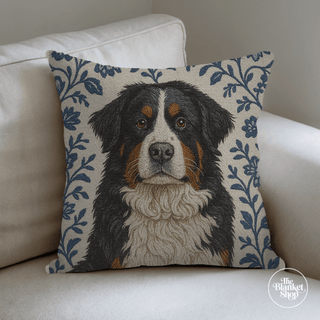 Pillow with a dog's face on a floral patterned background and The Blanket Shop Logo