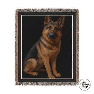 Woven blanket with a German Shepherd design on a black background, featuring 'The Blanket Shop' logo.