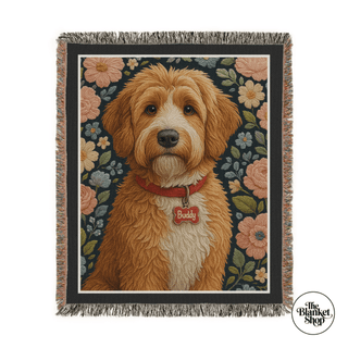 Woven blanket with a dog illustration and floral patterns, featuring 'The Blanket Shop' logo.