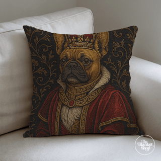 Woven throw pillow with a dog in regal attire on a white couch from The Blanket Shop