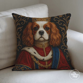 Personalized throw pillow with a dog's portrait in regal attire on a white couch with The Blanket Shop Logo