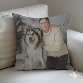 Personalized pillow with a photo of a woman and her dog on a beige couch with The Blanket Shop Logo