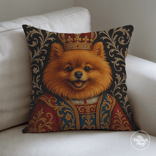 Personalized throw pillow with a dog's portrait in royal attire on a white couch with The Blanket Shop Logo